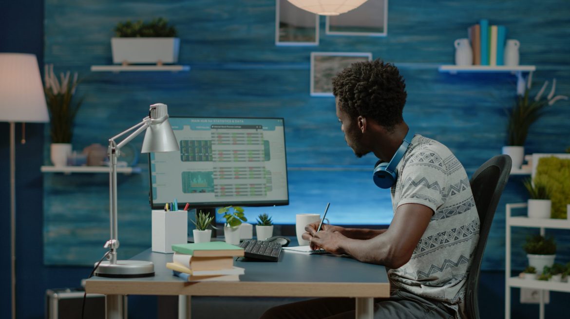 Black man looking at stock market exchange information